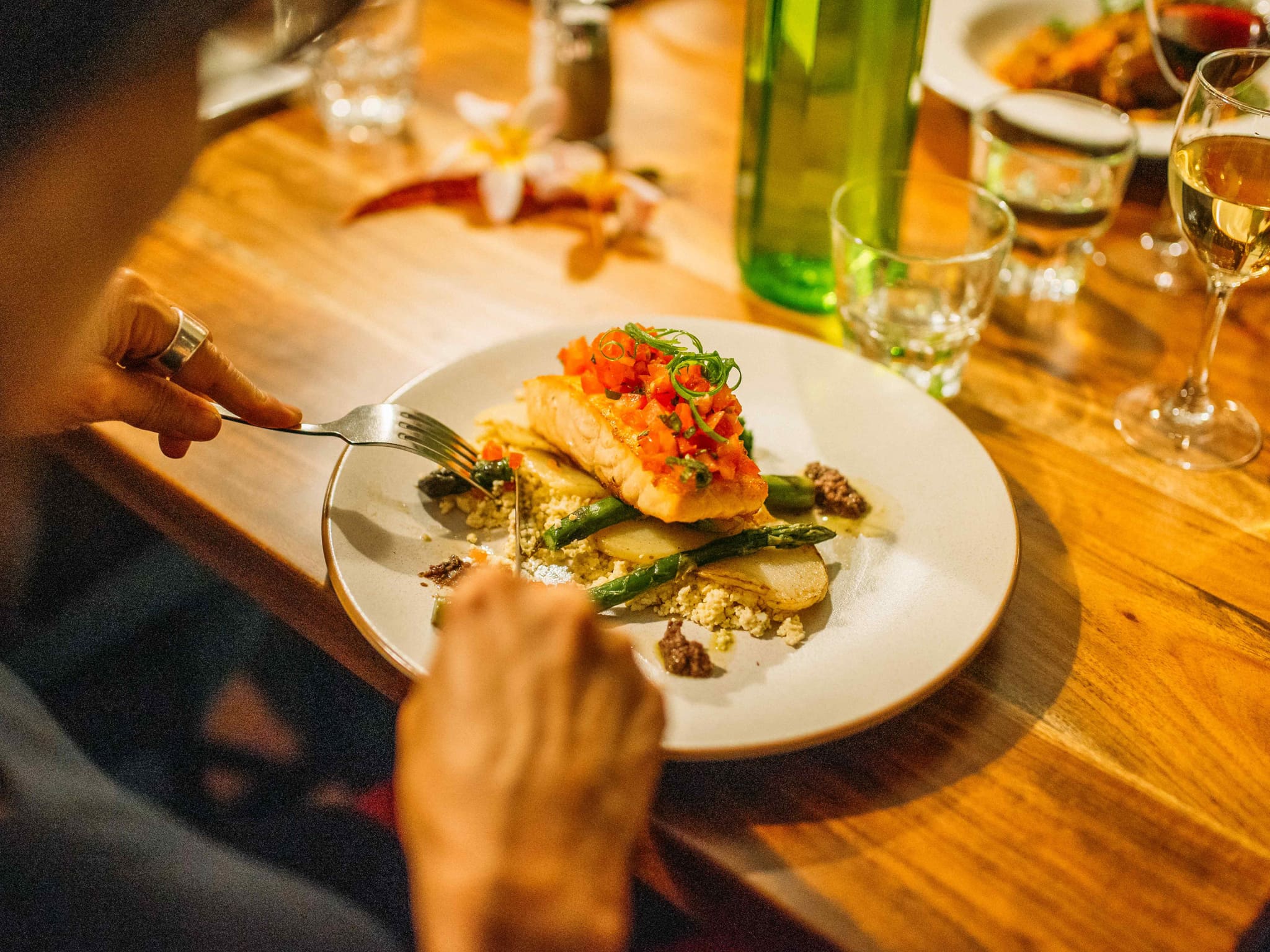 Person eating fish for dinner at Bailey's Restaurant at Governor's Lodge on Norfolk Island
